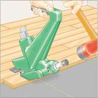Illustration of a man’s hand, hammering a mechanical flooring nailer to secure wood flooring.
