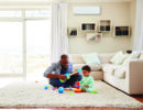 Father and toddler son playing in the sitting room