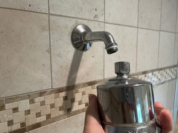 Manually unscrew shower head from shower arm