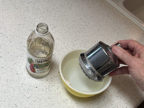 put the shower head in a 50/50 mixture of water and vinegar