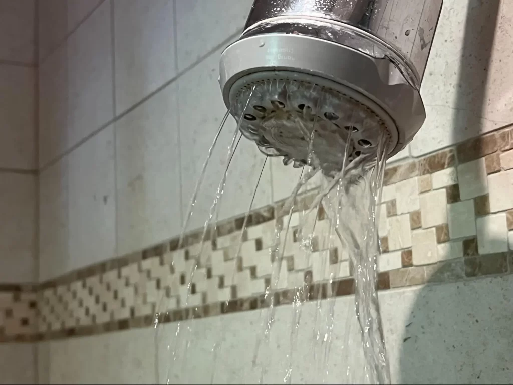 When a shower head loses the power behind its spray, the cause is usually mineral buildup.