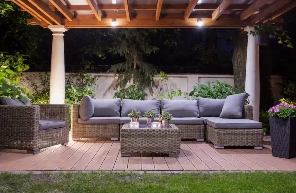 A classic pergola provides shade and structure for a comfortable seating area in this inviting backyard.