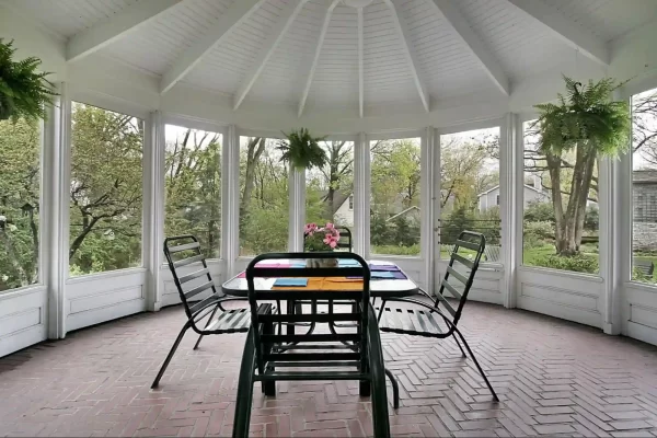 An elegant multi-sided gazebo serves as the centerpiece of this backyard, providing a stylish space for outdoor gatherings.