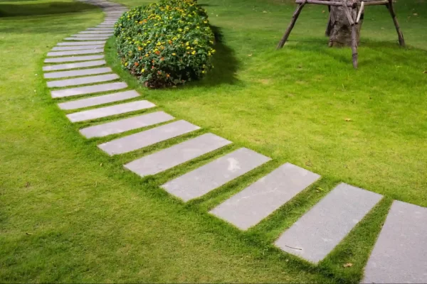 A garden path with sleek stone slabs placed at equal distances for a clean and contemporary look. 