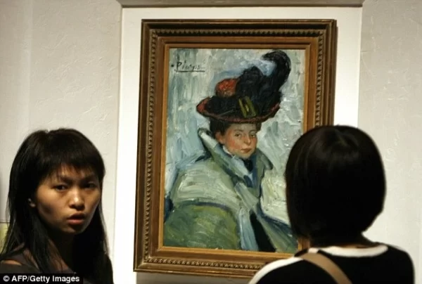 Visitors admiring a Picasso painting - Woman With A Cape at Beijing’s World Art Museum in 2006