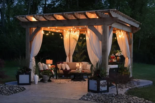 Rustic charm abounds in this backyard, where a wooden pergola complements the natural stone and concrete elements.