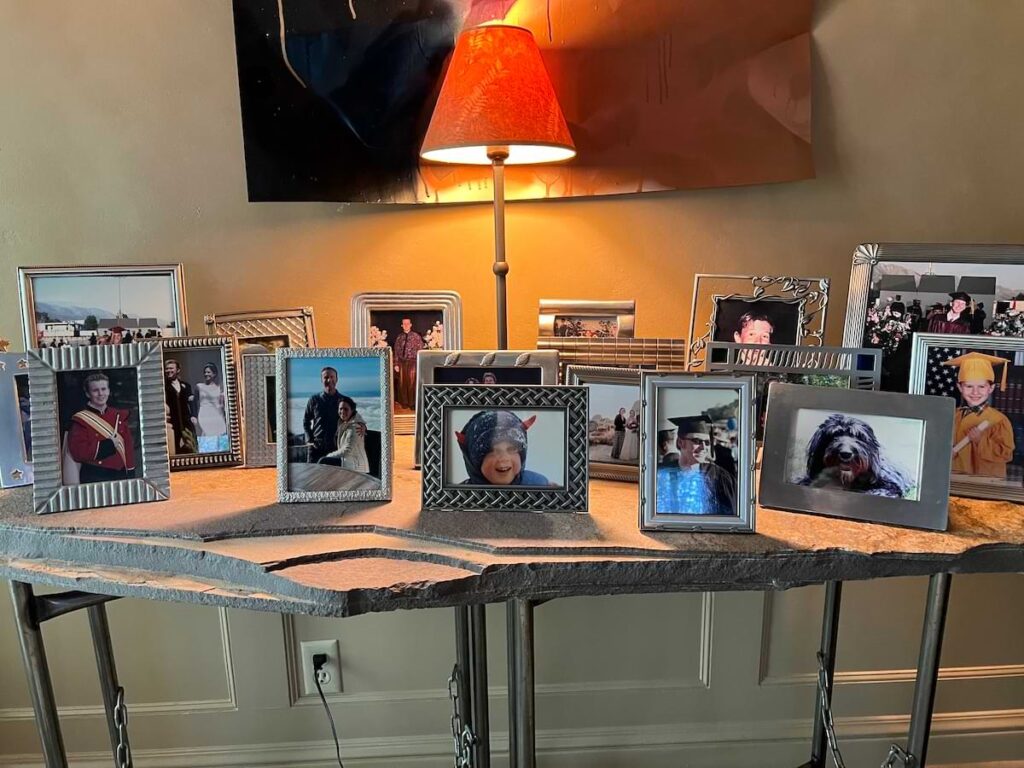 Entryway table welcomes guests with a display of family photos.