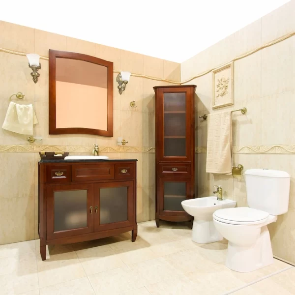 Wooden furniture, mirror and metallic accents on bulb holders give a vintage look to this bathroom.