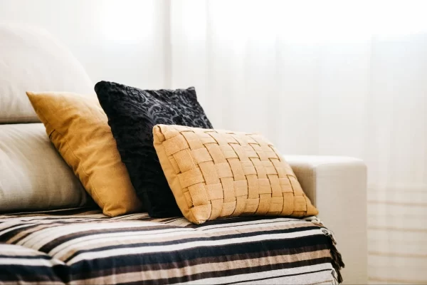 Caption: Throw pillows with various patterns and textures add uniqueness and depth.