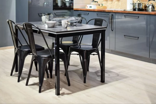 Black and compact, this compact, this dining table seats 4 next to the kitchen.