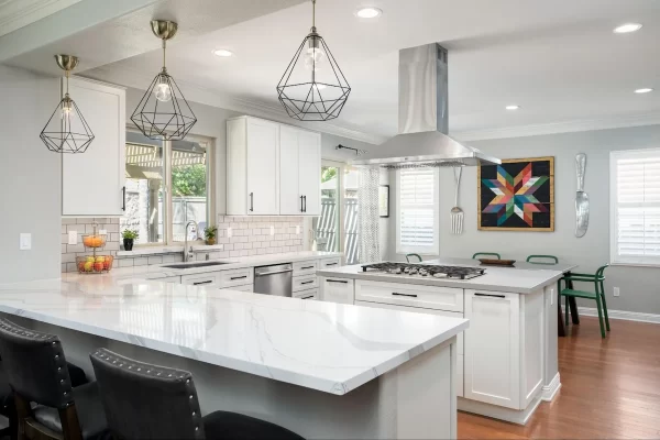 This kitchen island with a built-in stove places cooking in the center of the workspace.