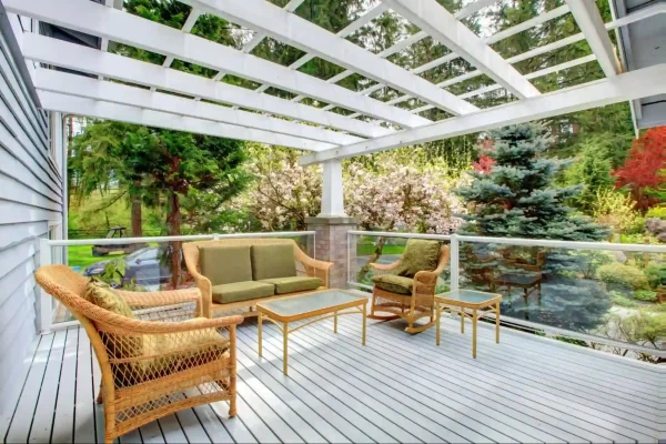 A muted, light-toned pergola anchors this serene backyard retreat that offers an unobstructed view of the garden.