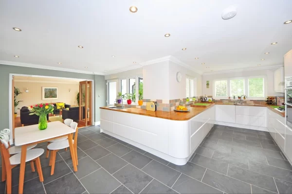 Large kitchen with wrap-around cabinets has plenty of space for preparation and serving, situated next to the table and chairs.