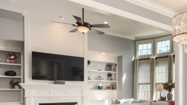  Dark blades of this ceiling fan contrasts with the decor while the lighting fixture increases functionality and style. 