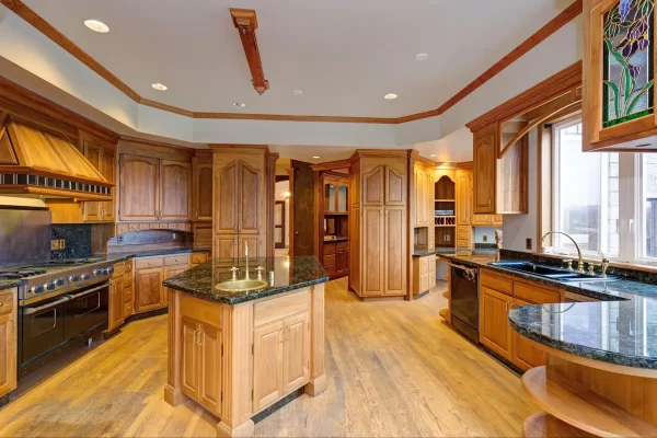 A compact kitchen island with a unique design stands out as a center of attraction in this kitchen. 