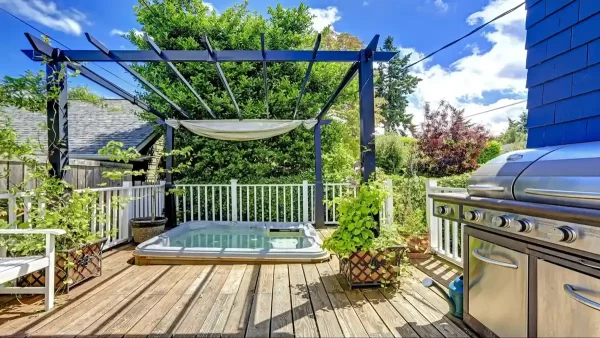 This deck's built-in hot tub invites you to soak away your cares in a serene outdoor oasis.