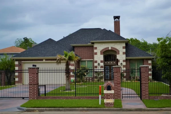 The broad rhombus shapes tiles in both driveway and walkway creates a cohesive exterior for this home.