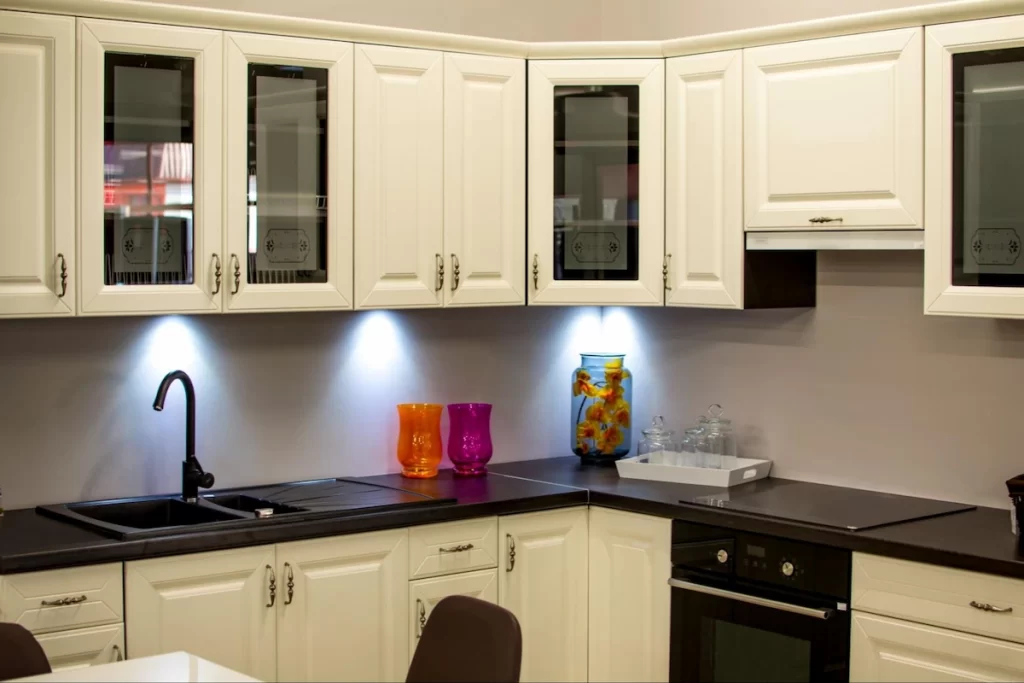 Glass doors are the perfect partner for these white cabinets, adding visual interest.