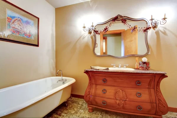 This mirror’s interesting shape and rustic metallic frame make this bathroom serene and charming.