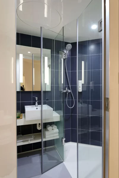 Bold black tiles in the shower area bring a contrast and elegance to this bathspace. 