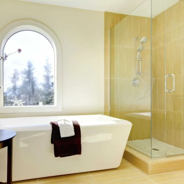 These bright neutral rectangular tiles elongate the shower space.