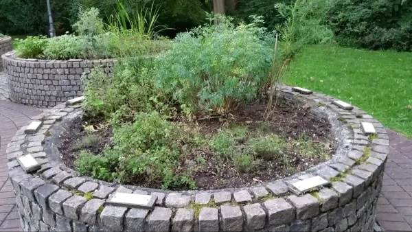 Circular stone raised garden beds are highly durable and require minimal maintenance.