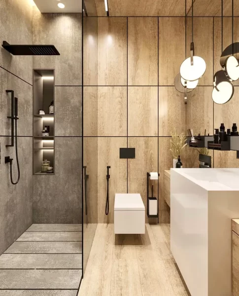 Wooden accents in the shower area and the brass shine of hanging lighting fixtures create a warm and slightly luxe look in this bathroom.