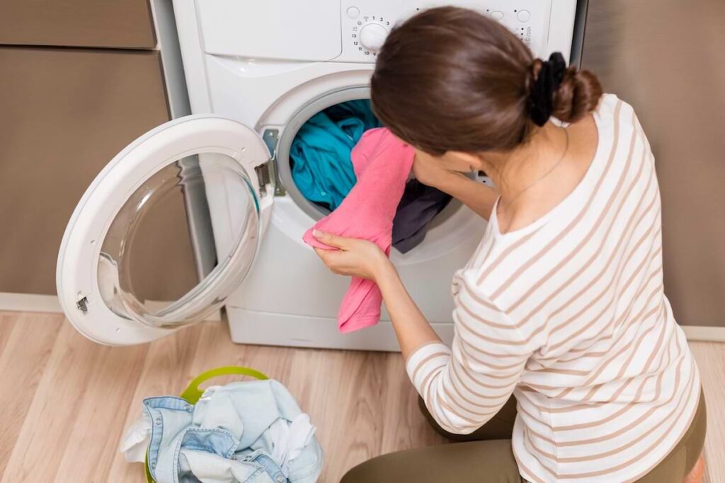 lady taking wash out of washing machine