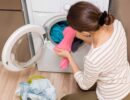 lady taking wash out of washing machine