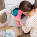 lady taking wash out of washing machine