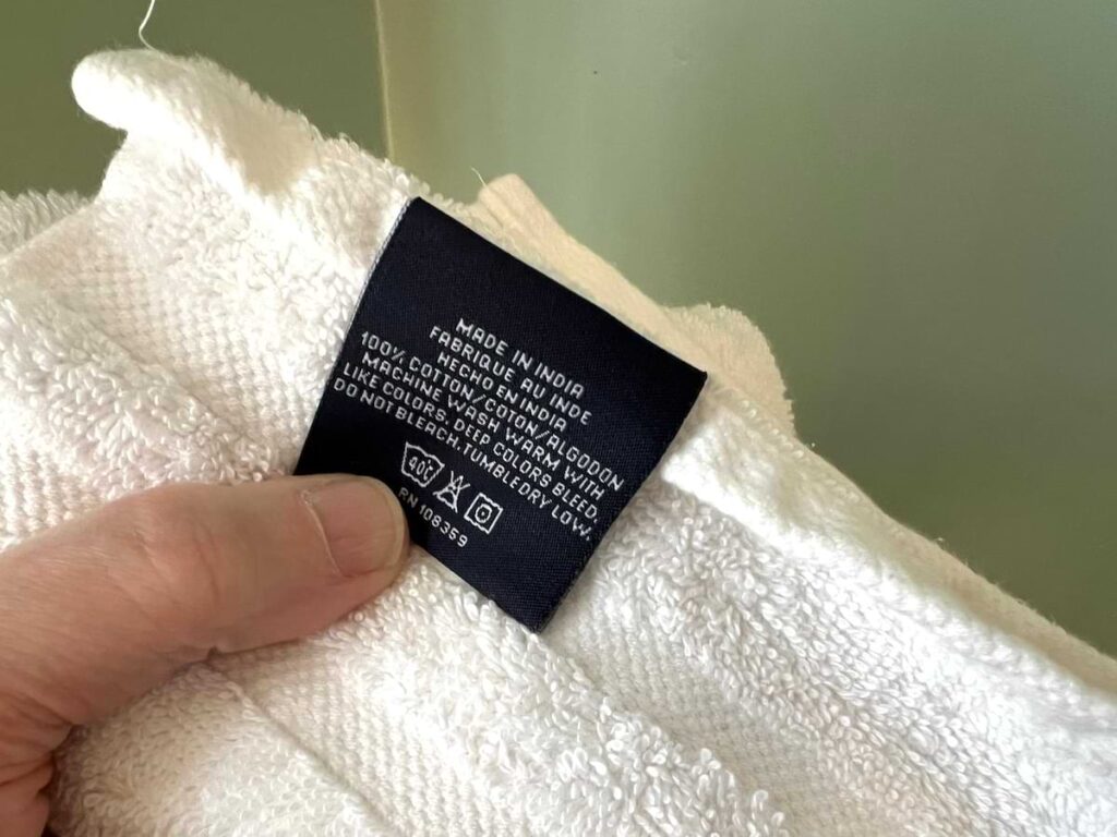 checking label on cotton towel